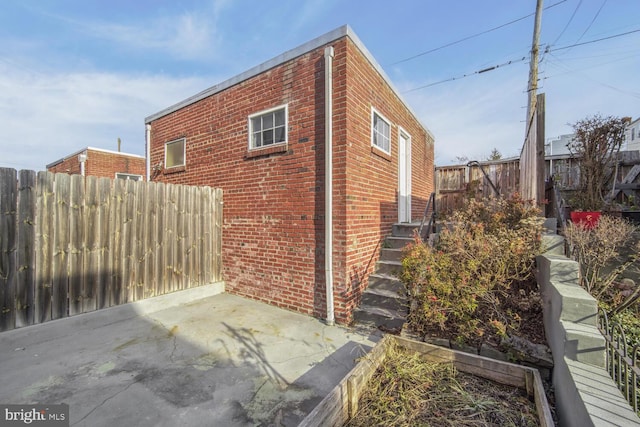 view of property exterior with a patio area