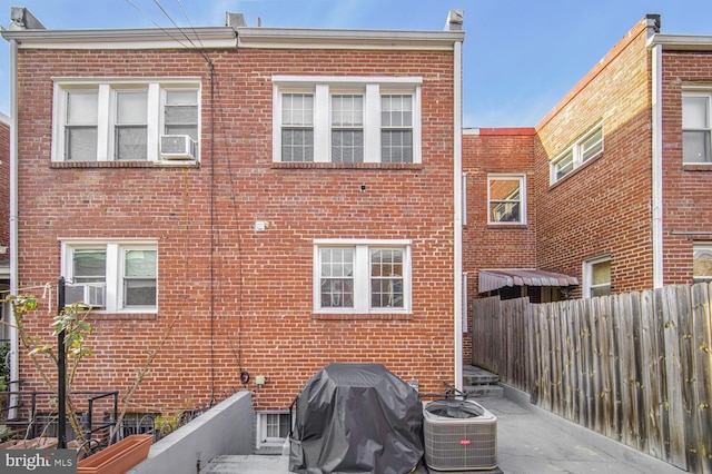 rear view of house featuring central AC and cooling unit