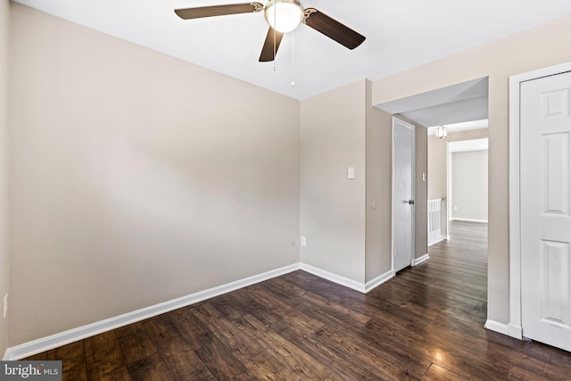 unfurnished room with ceiling fan and dark hardwood / wood-style flooring