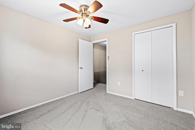 unfurnished bedroom featuring a closet, light colored carpet, and ceiling fan