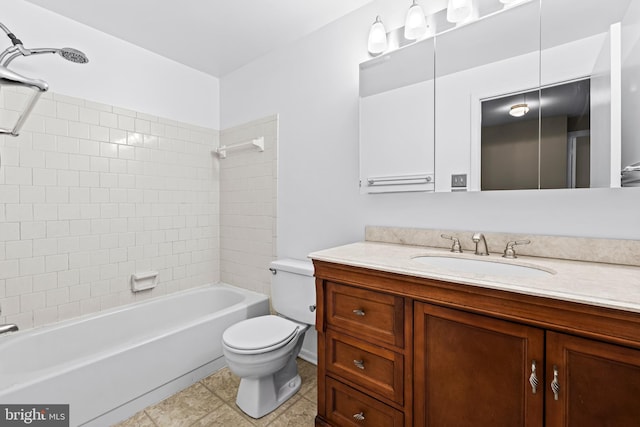 full bathroom featuring tile patterned flooring, tiled shower / bath combo, toilet, and vanity