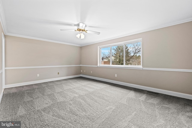 spare room featuring carpet, ceiling fan, and ornamental molding