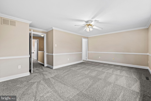 carpeted spare room with ceiling fan and ornamental molding