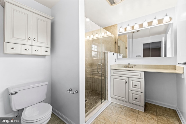 bathroom featuring vanity, toilet, and an enclosed shower