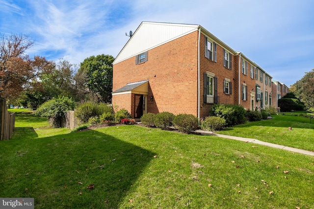 view of side of property with a lawn