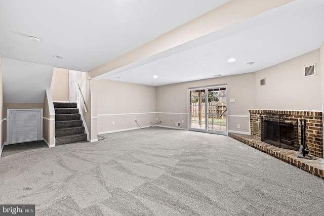 unfurnished living room with carpet flooring and a brick fireplace