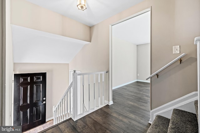 foyer featuring dark hardwood / wood-style flooring and vaulted ceiling