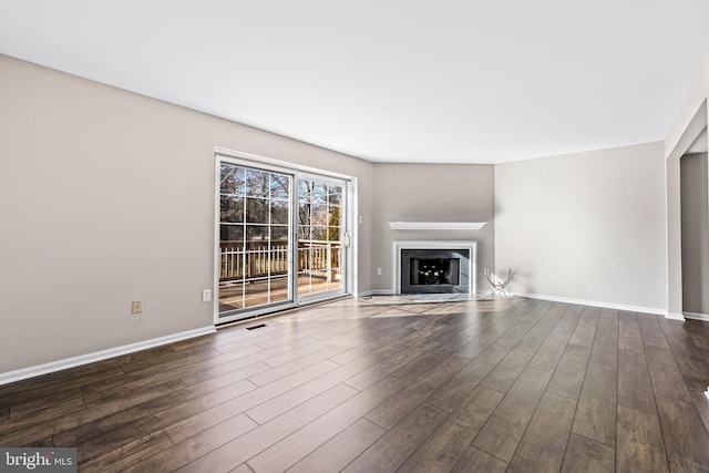 unfurnished living room with dark wood-type flooring