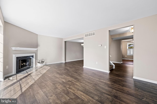 unfurnished living room featuring dark wood-type flooring