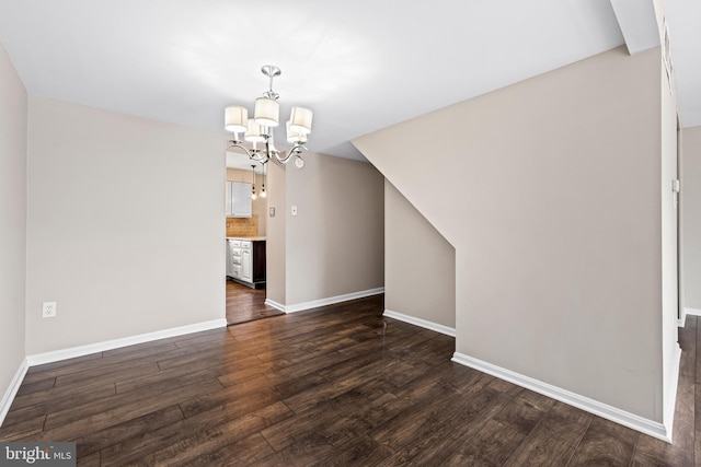 interior space with a notable chandelier and dark hardwood / wood-style flooring