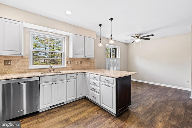 kitchen with white cabinets, dishwasher, kitchen peninsula, and sink