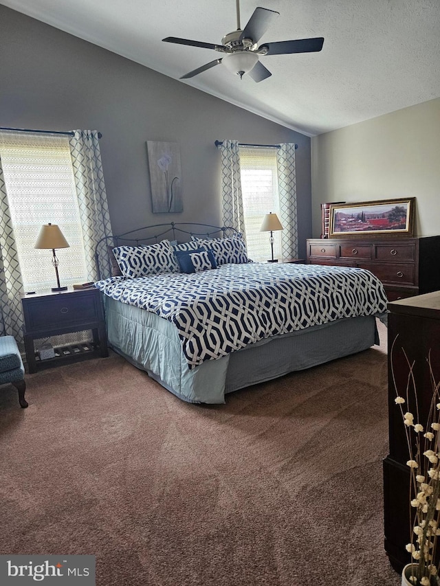 bedroom featuring a textured ceiling, a ceiling fan, lofted ceiling, and carpet floors