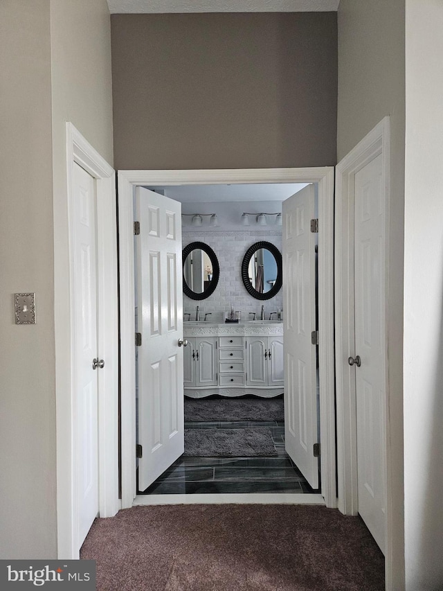 interior space with dark carpet and a sink