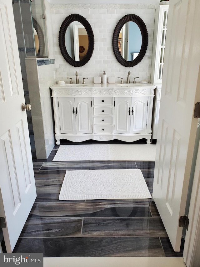 full bath with a sink and double vanity