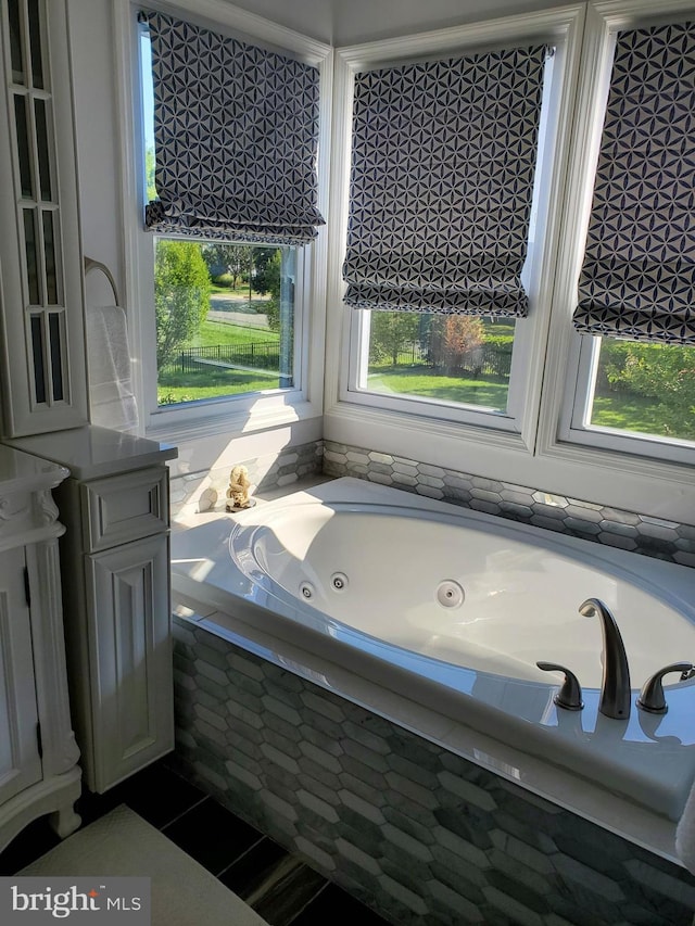 full bathroom featuring a jetted tub