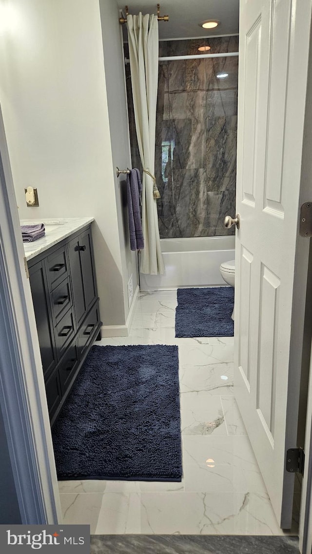 full bathroom featuring vanity, baseboards, shower / bath combination with curtain, toilet, and marble finish floor