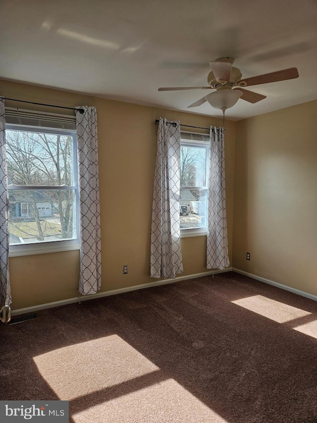 unfurnished room featuring baseboards, ceiling fan, and carpet flooring