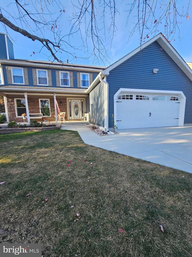 view of property featuring a porch, a front yard, a chimney, a garage, and driveway