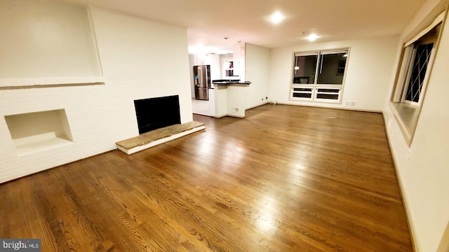 unfurnished living room featuring wood-type flooring