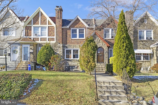 tudor-style house with a front yard