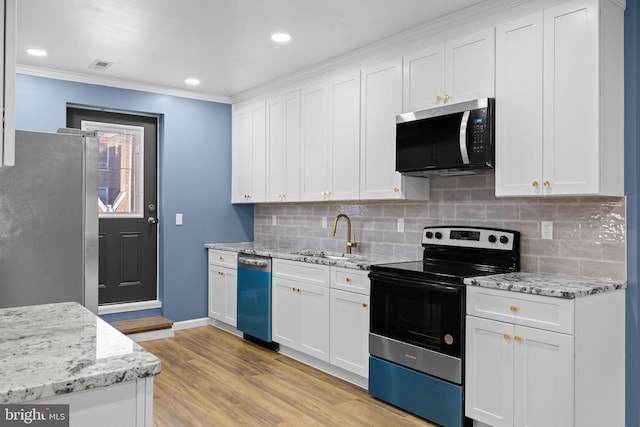 kitchen featuring light stone countertops, sink, light hardwood / wood-style floors, white cabinets, and appliances with stainless steel finishes