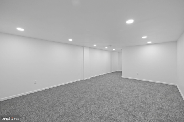 basement featuring dark colored carpet