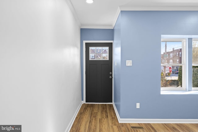 entrance foyer featuring hardwood / wood-style flooring and ornamental molding