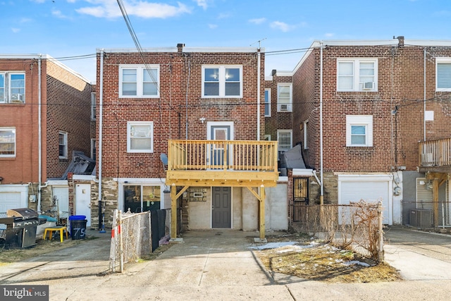 back of house featuring a wooden deck and central AC unit