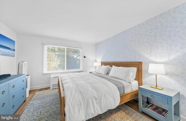 bedroom with dark wood-type flooring