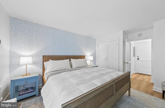 bedroom with hardwood / wood-style flooring and a closet