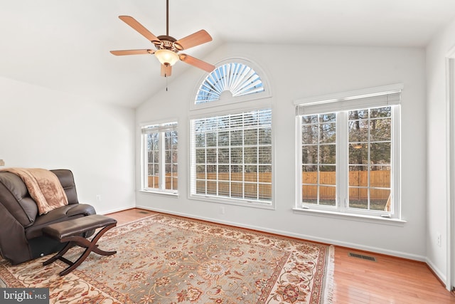 sitting room with vaulted ceiling, ceiling fan, and light hardwood / wood-style floors