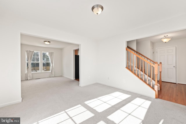 unfurnished room with light colored carpet