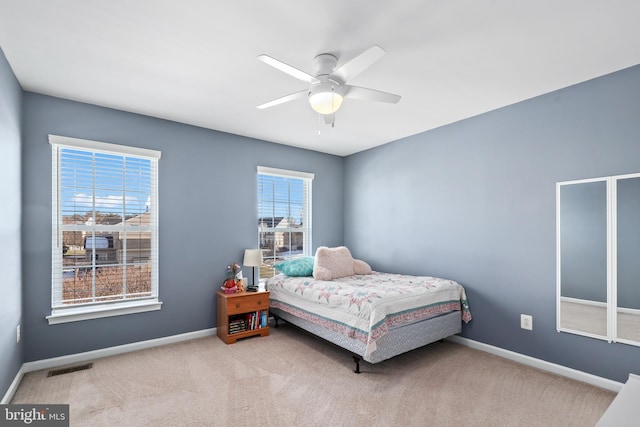 bedroom featuring ceiling fan and light carpet