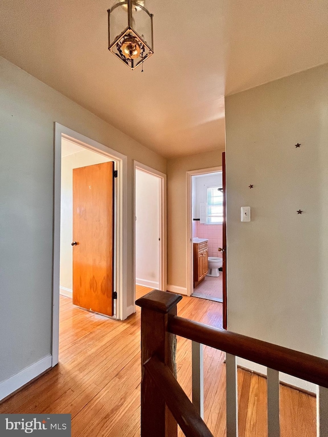 hallway with light hardwood / wood-style floors