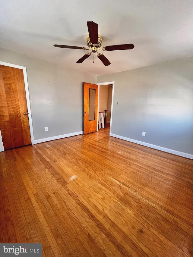 unfurnished bedroom with ceiling fan, a closet, and light hardwood / wood-style flooring