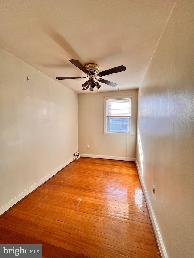 empty room with light hardwood / wood-style floors and ceiling fan