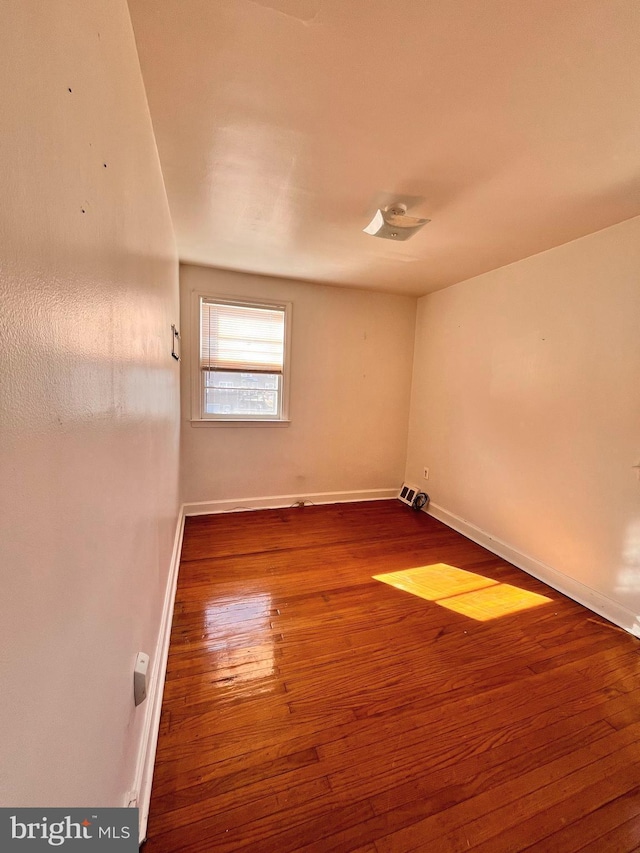 spare room with hardwood / wood-style floors