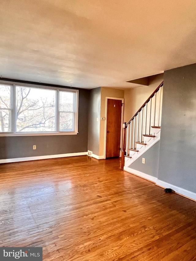 unfurnished living room featuring hardwood / wood-style floors