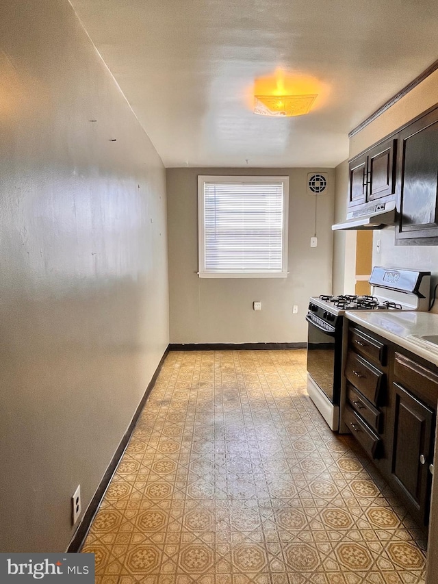 kitchen featuring dark brown cabinets and range with gas stovetop