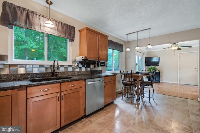 kitchen with sink, pendant lighting, dishwasher, and ceiling fan