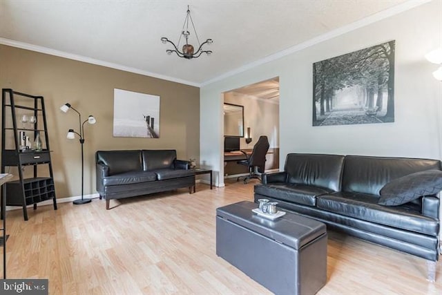 living room with ornamental molding, a notable chandelier, and wood-type flooring