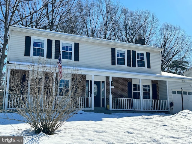 view of front property with covered porch and a garage