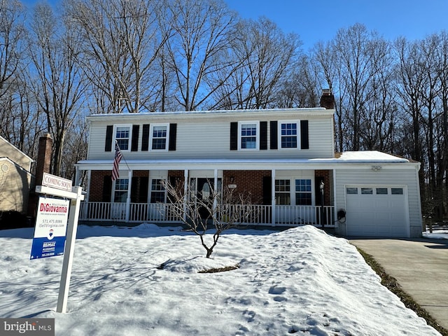 view of front facade with a porch and a garage