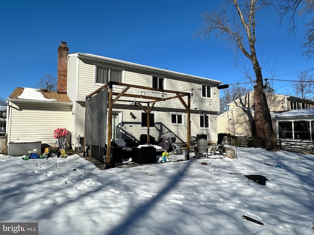 view of snow covered rear of property