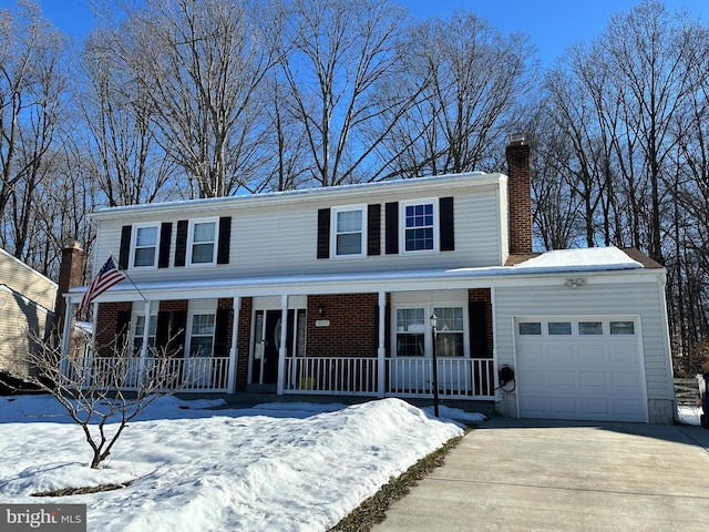 view of front of property featuring covered porch and a garage