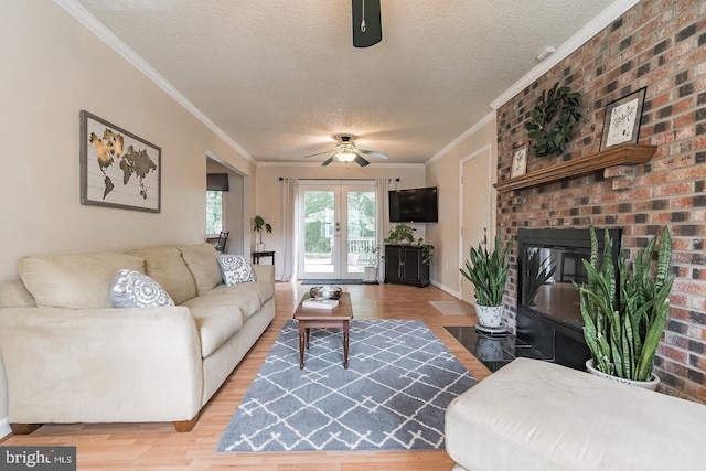 living room featuring french doors, a textured ceiling, ornamental molding, and wood-type flooring