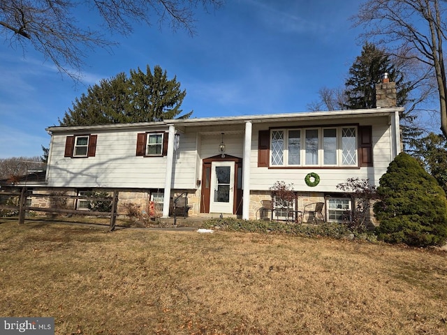 raised ranch with a front lawn