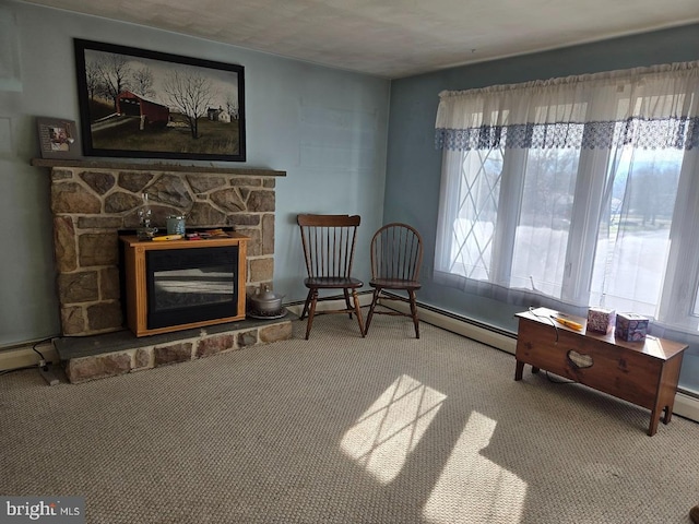 sitting room featuring carpet flooring, a fireplace, and a baseboard radiator