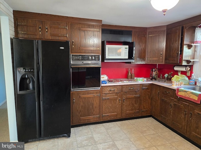 kitchen featuring black appliances and sink