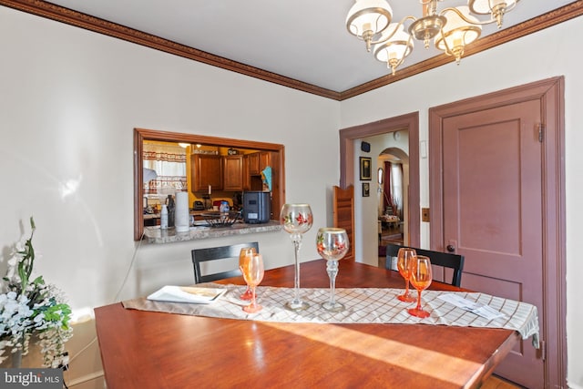 dining space featuring an inviting chandelier and ornamental molding